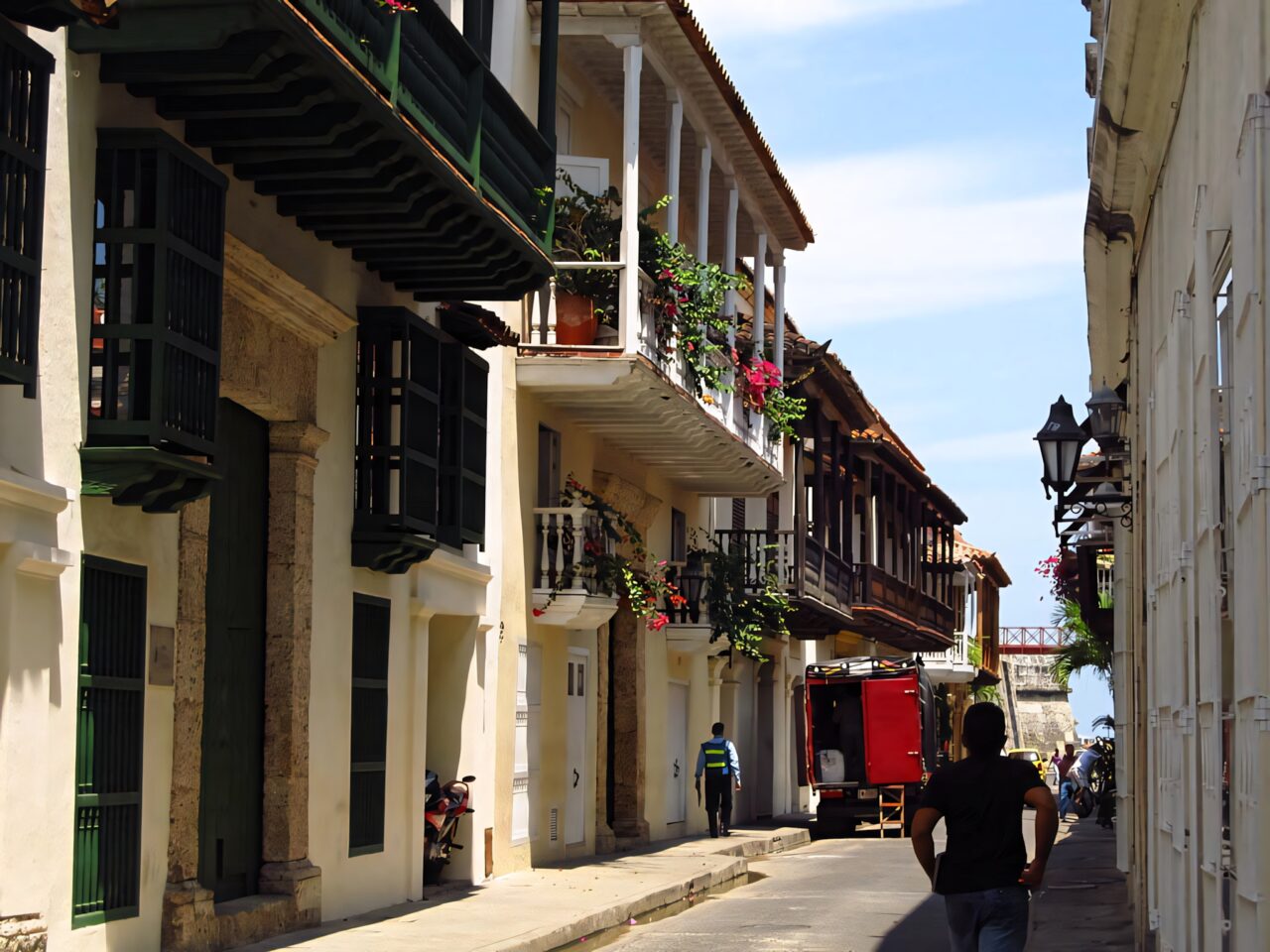 Colonial street in Cartagena colorful balconies flowers historic architecture bright sunlight wallpaper