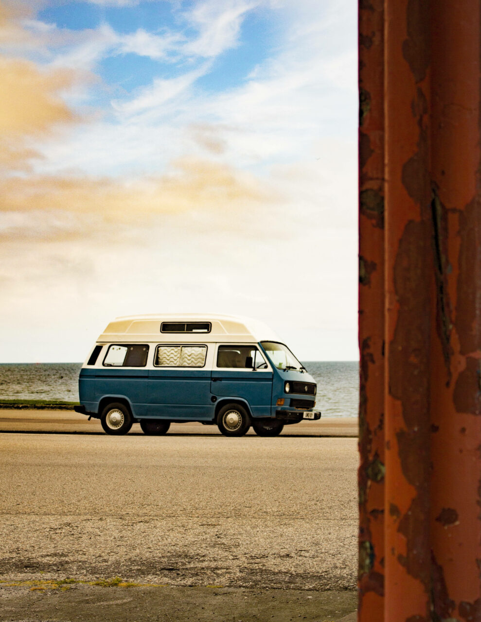 Groovy Ride: Nostalgic Beachside Journey with Vintage Volkswagen Type 2 Camper Van Wallpaper