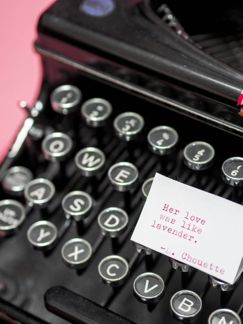 Vintage typewriter with romantic lavender love note on pastel pink background wallpaper