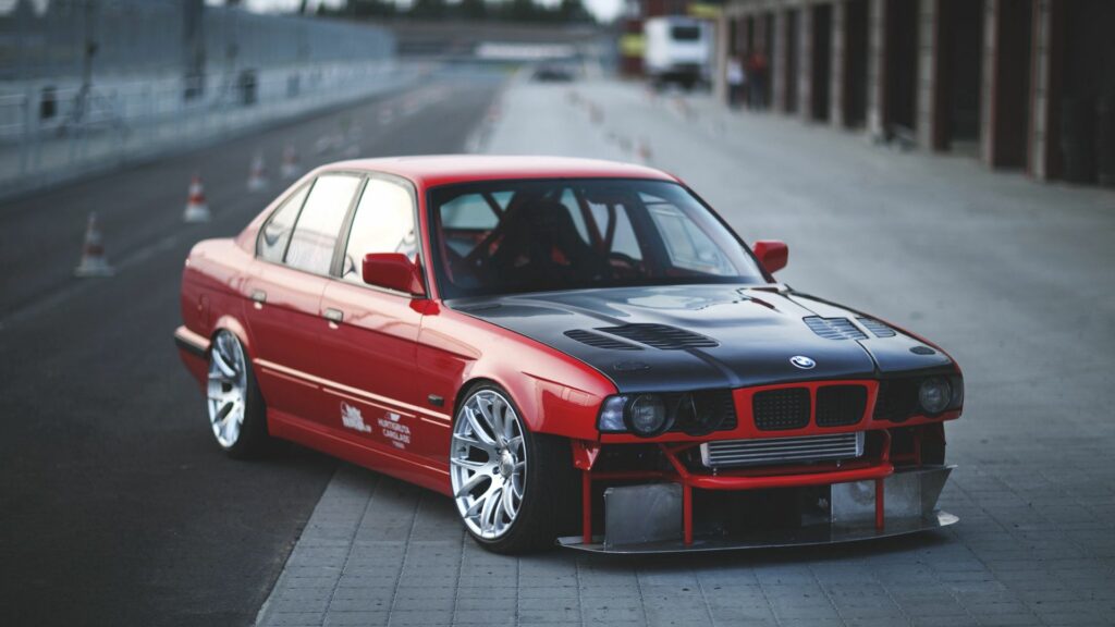 Stunning Red BMW E34 Sports Car Wallpaper - 1920x1080 Racetrack View