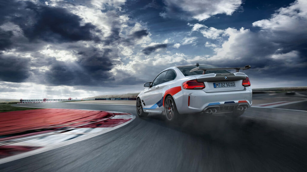 Dynamic Drive: BMW M2 in Full Swing on a Scenic Twisting Road Wallpaper
