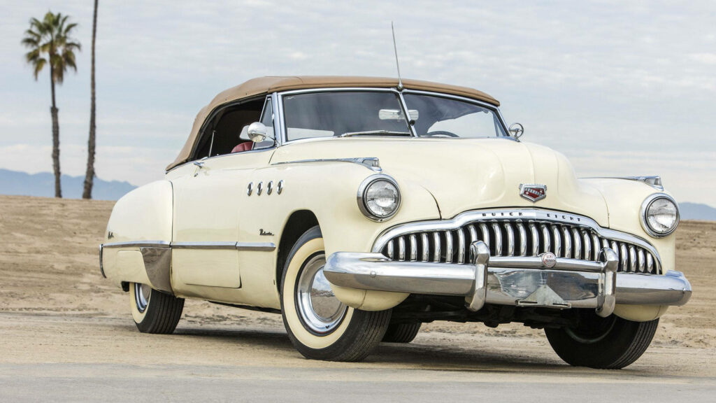 1949 Buick Roadmaster classic car wallpaper with palm trees and mountain landscape background