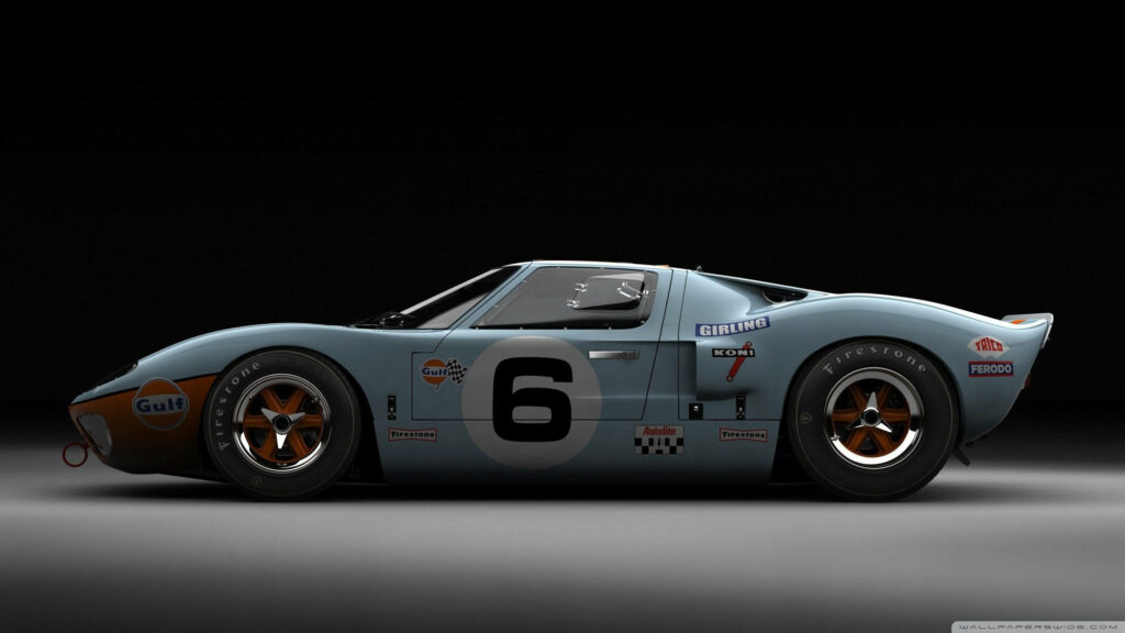 Side profile of 1968 Ford GT40 Gulf livery with racing decals and bold number 6 on dark background Wallpaper