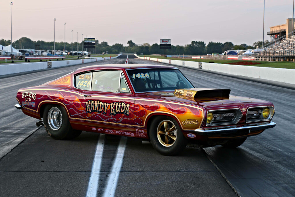 Red 1968 Plymouth Barracuda with flame graphics on drag strip vintage muscle car wallpaper