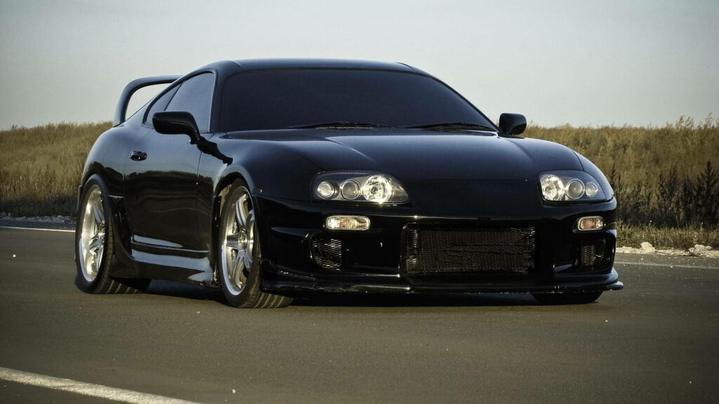1998 black Toyota Supra Mk4 parked on open road showing sleek aerodynamic design and stance Wallpaper