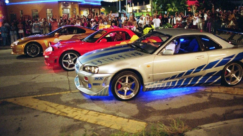 Night drag racing wallpaper featuring Nissan Skyline R34, Mazda RX-7, and Toyota Supra cars