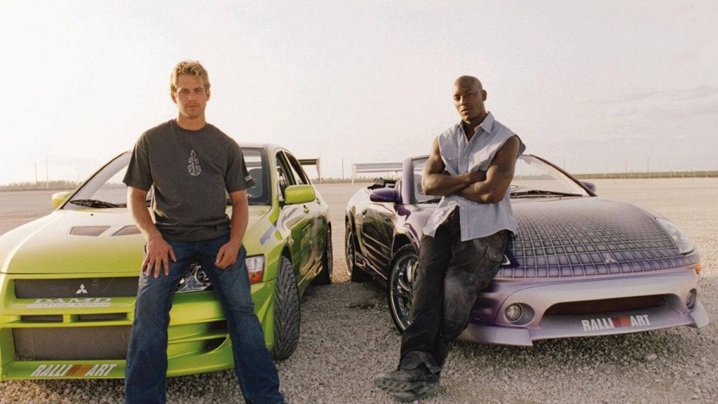 Paul Walker and Tyrese Gibson with green Lancer Evo and purple Eclipse Spyder Fast Furious wallpaper