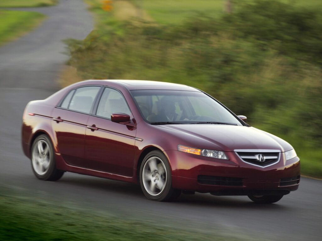 2004 Acura TL: Stylish Red Car Amidst Lush Greens - Wallpaper