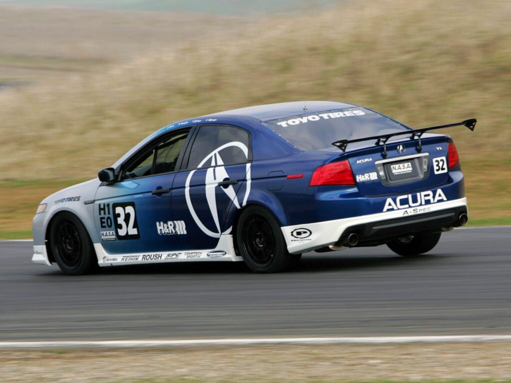 Dynamic Side View of Blue 2004 Acura TL on Asphalt Road Wallpaper