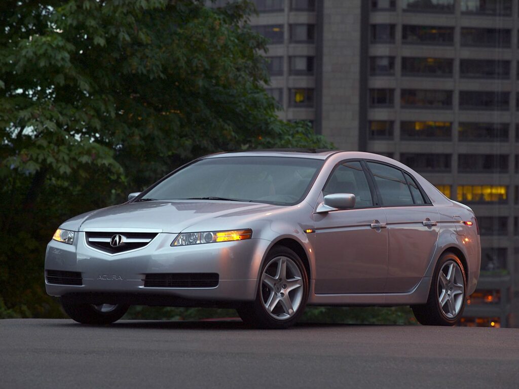 Stylish Side View: 2004 Silver Acura TL on Urban Asphalt Background Wallpaper