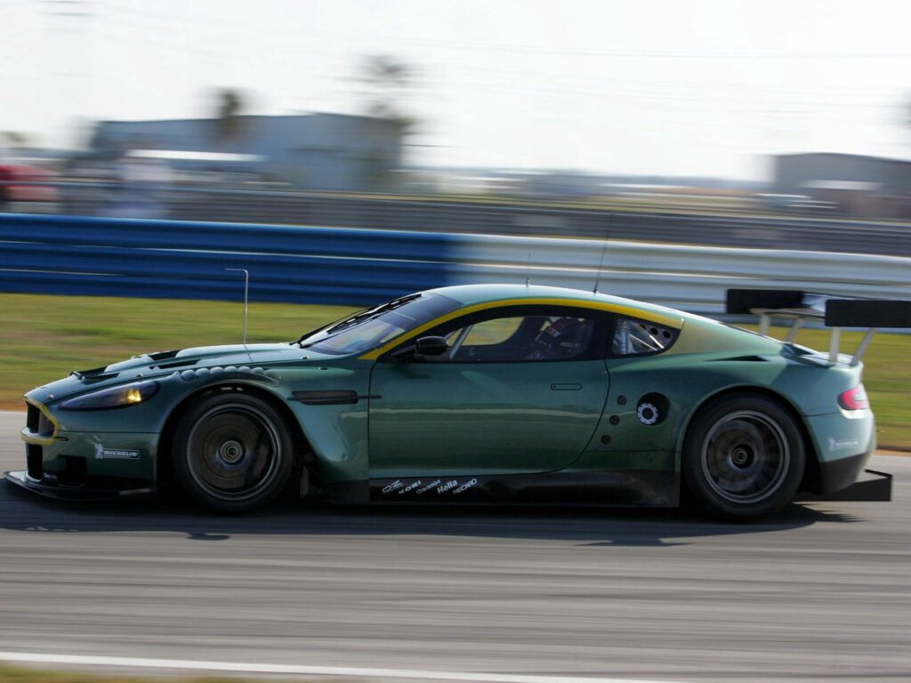 2005 Aston Martin DBR9 Green: Sleek Racing Scene on Asphalt Wallpaper