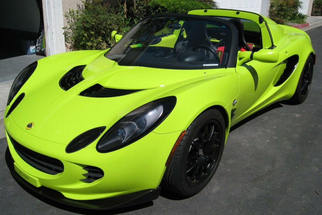 Vibrant lime green 2005 Lotus convertible sports car parked showing sleek design wallpaper background
