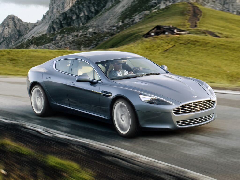 Sleek Gray 2009 Aston Martin Rapide on Winding Road Wallpaper