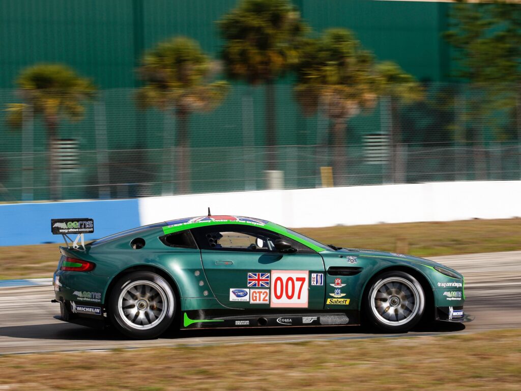 Sleek Green 2009 Aston Martin V8 Vantage - Dynamic Side View Wallpaper