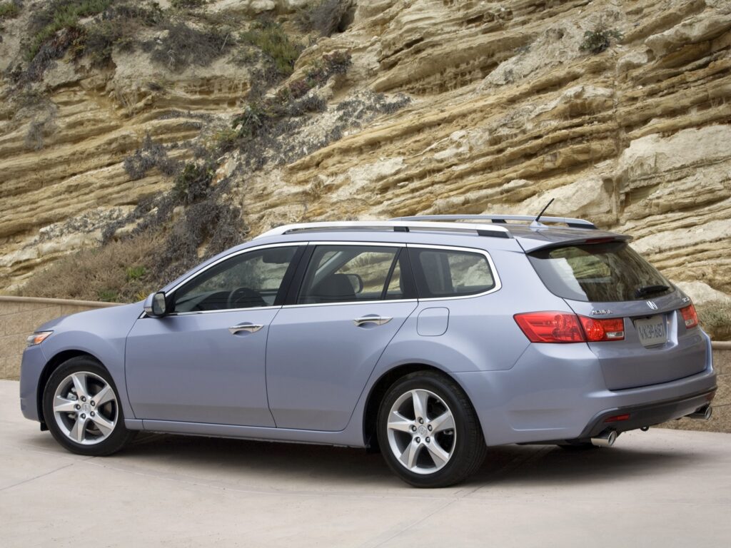 2010 Acura TSX in Sleek Blue Metallic with Rugged Rock Background Wallpaper