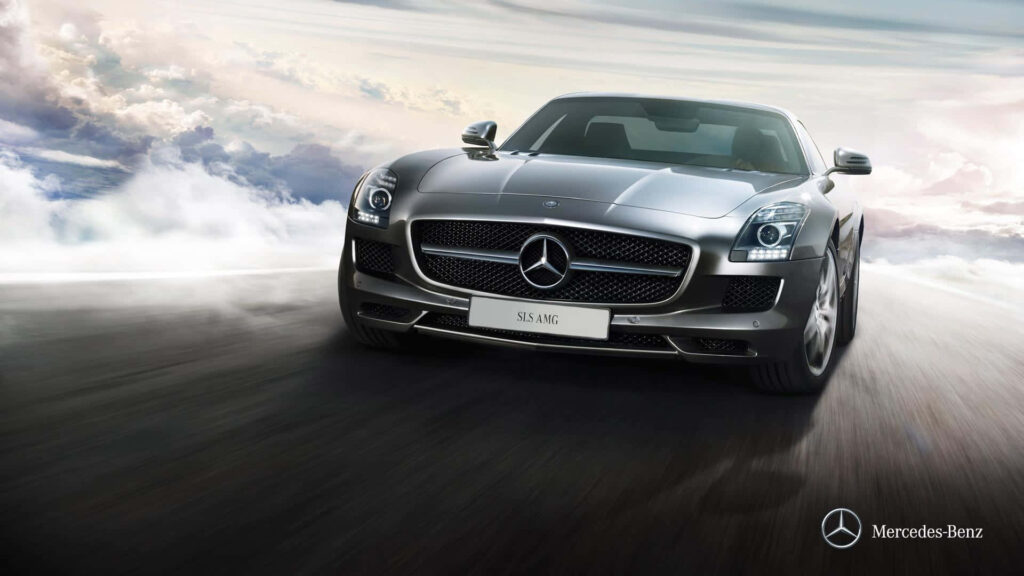 Grey 2011 Mercedes-Benz SLS AMG speeding under dramatic sky showcasing luxury performance Wallpaper