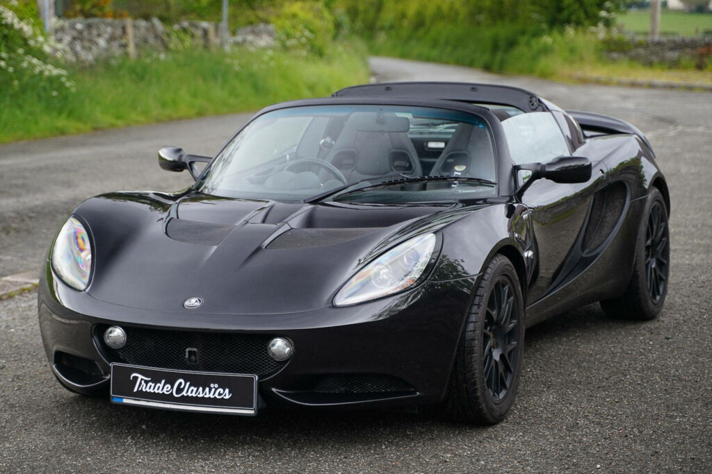 2013 black Lotus Elise convertible parked on a quiet road highlighting sporty aerodynamic design Wallpaper