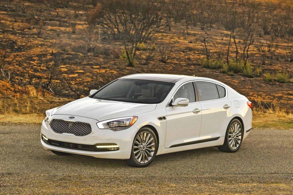 2015 Kia Sedan Wallpaper: Elegant Design on Rustic Background