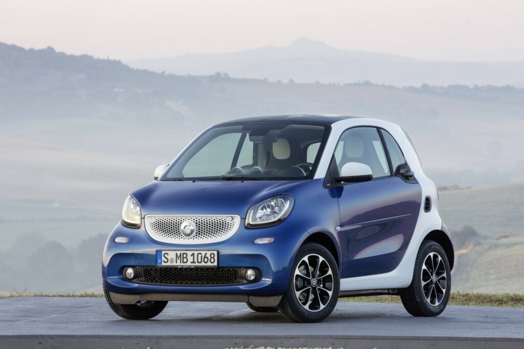 2015 Smart Fortwo Wallpaper: Sleek Design in Mountainous Background