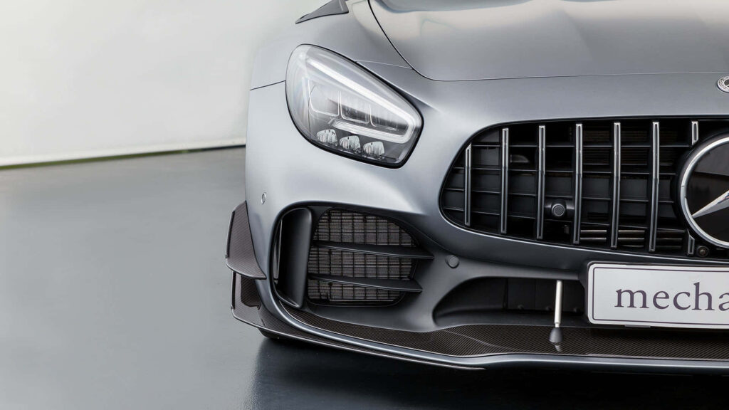 Front view of 2018 AMG GT R with sleek headlights and aggressive grille on wallpaper background