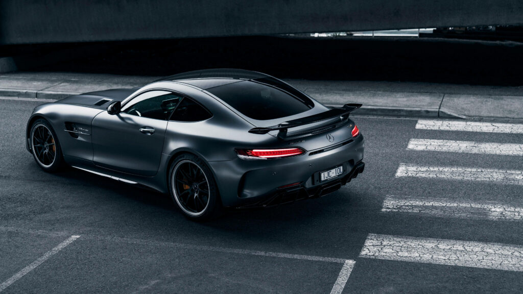 2018 Mercedes-AMG GT R with sleek aerodynamic design and sporty spoiler on urban street background Wallpaper