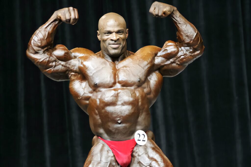 Professional bodybuilder posing on stage at 2018 Mr Olympia with defined muscles and strength Wallpaper