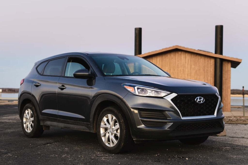 2019 Hyundai Tucson Wallpaper: Sleek SUV by a Rustic Cabin