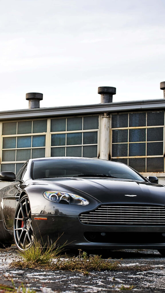 2020 Aston Martin Vantage sleek sports car against rugged industrial background wallpaper