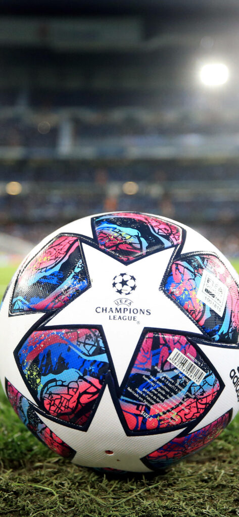 2020 Champions League Ball with red blue stars on stadium backdrop vibrant football wallpaper
