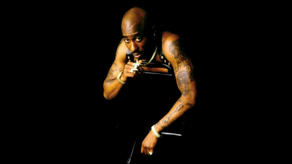 Glamorous 2Pac: A Dazzling Showcase Against the Shadows Wallpaper