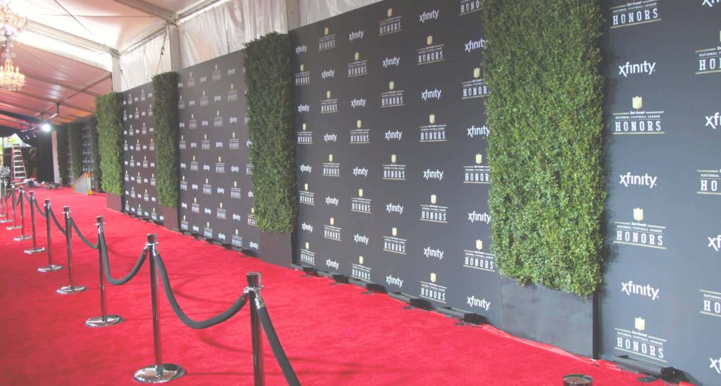 NFL Honors red carpet wallpaper with black Xfinity backdrop and velvet rope walkway background