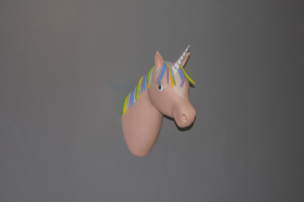 Whimsical 3D Unicorn Head Wallpaper with Colorful Mane on Gray