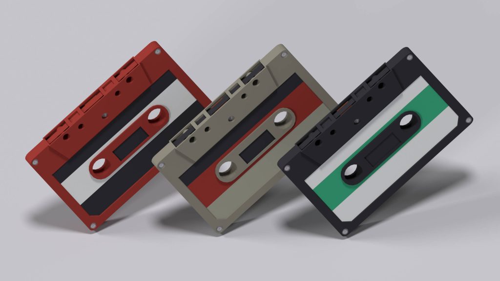 4D Ultra HD wallpaper of three retro cassettes red beige black on light grey background minimalist