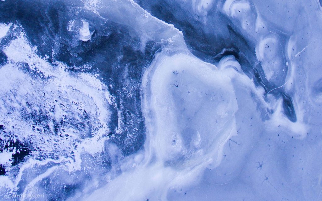 Abstract icy textures in 4K nature wallpaper with swirling frozen wave patterns in blue and white