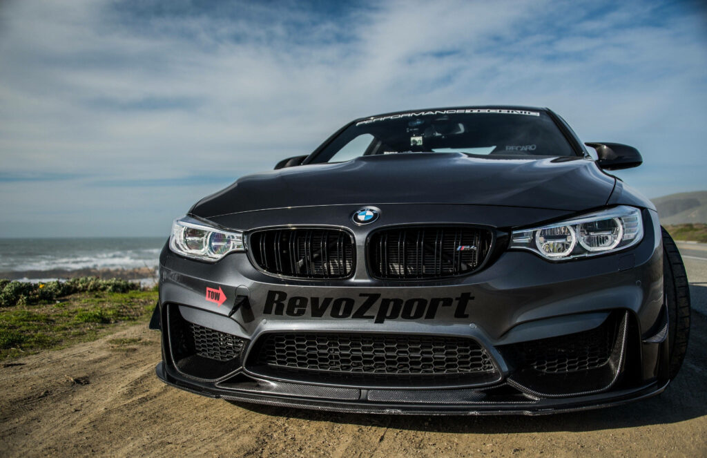 Sleek and Aggressive: Captivating 4k Background featuring a Black BMW M4 GTS with Striking Lowered Suspension Design Wallpaper