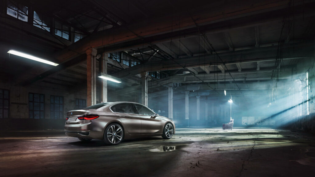 Dark Ambiance: Stunning 4k Background with a Black BMW Showcased in an Abandoned Warehouse Wallpaper