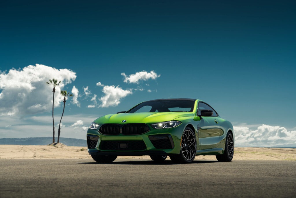 Roaming the Sandy Path: Captivating 4K Background Displaying a Stunning Green BMW Car in Daylight Wallpaper