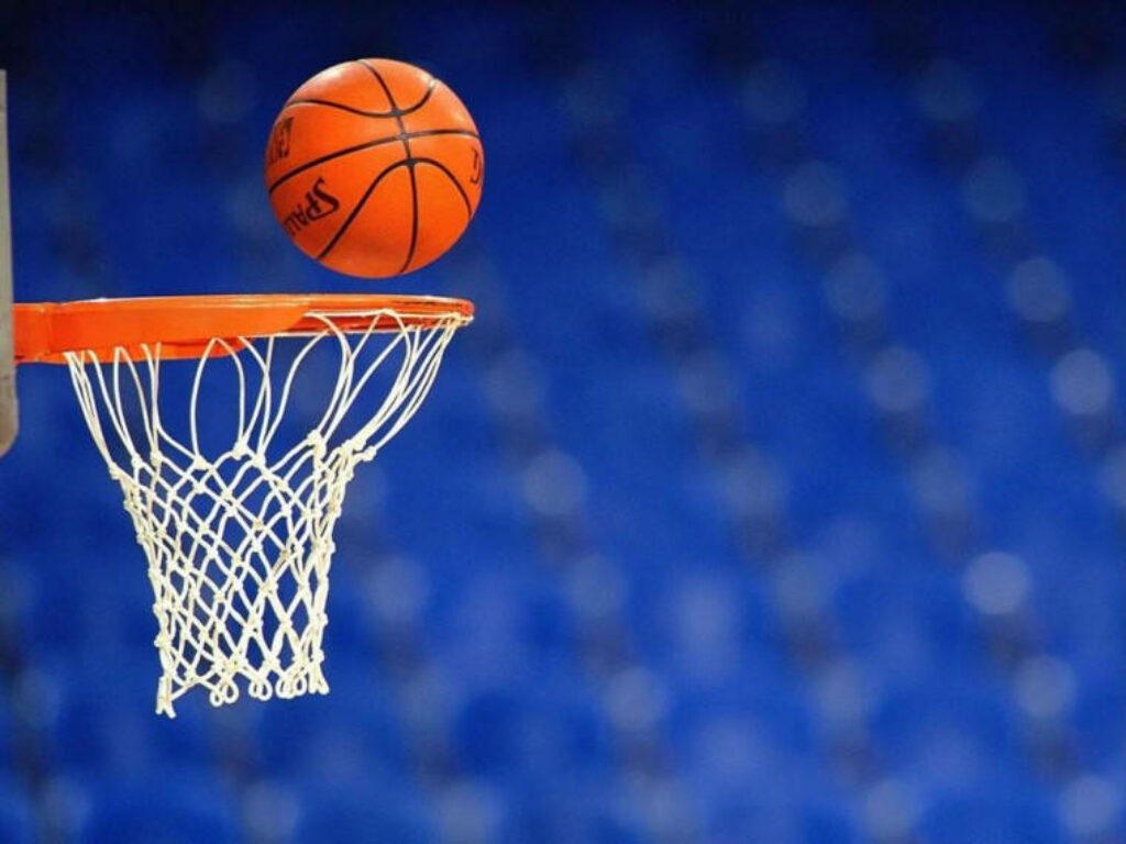4K Basketball Action Wallpaper: Mid-Air Shot Against Blue Background