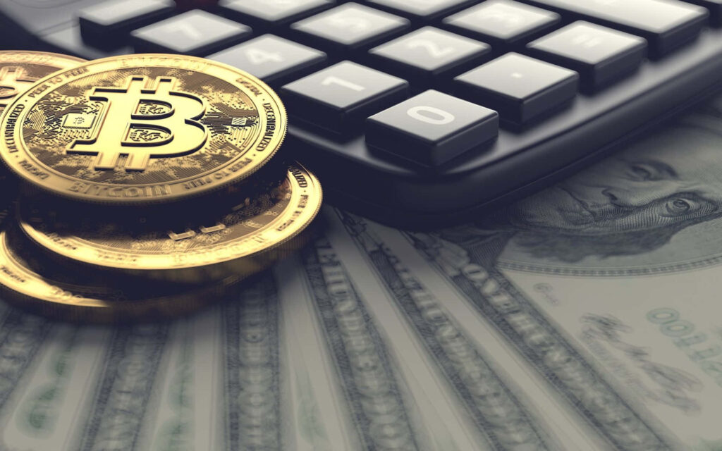 Close-up of shiny Bitcoin coins on US dollar bills with calculator showing crypto finance concept Wallpaper