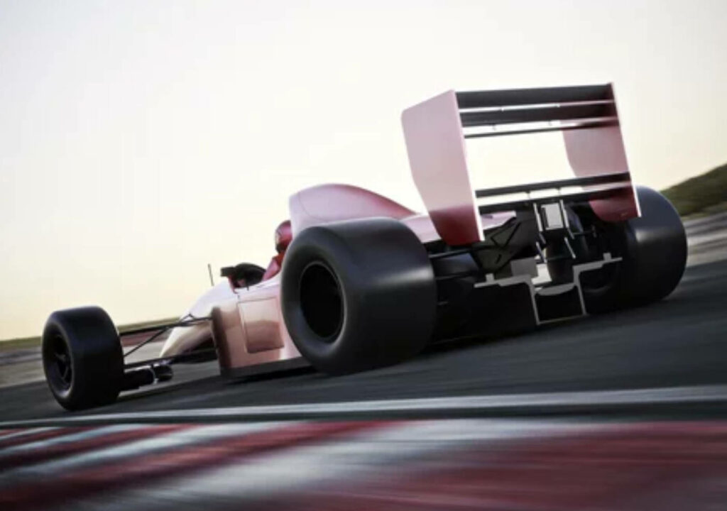 Back view of a high performance F1 car speeding on racetrack showcasing aerodynamic design 4K Wallpaper