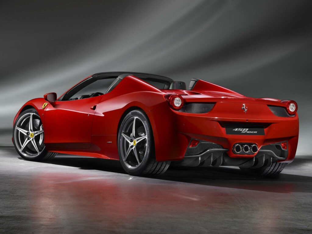 Sleek and Powerful: Captivating 4K Ferrari 458 Spider in Deep Red, Harmonizing with Mesmerizing Gray Abstract Wallpaper