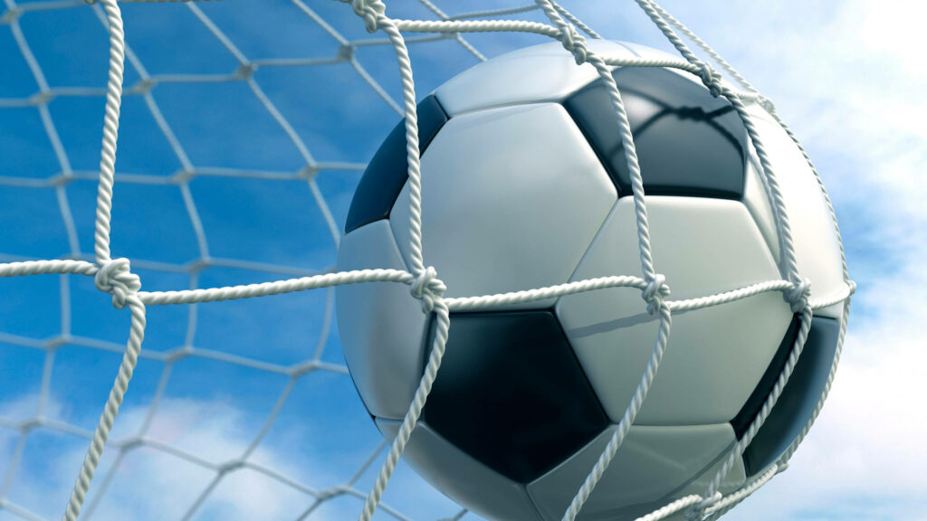 4k Football Soars to Victory in the Serene Sky of Fluffy Clouds Wallpaper