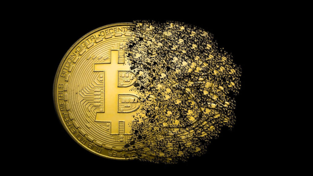 4k wallpaper of gold Bitcoin coin on black background with right side disintegrating into particles
