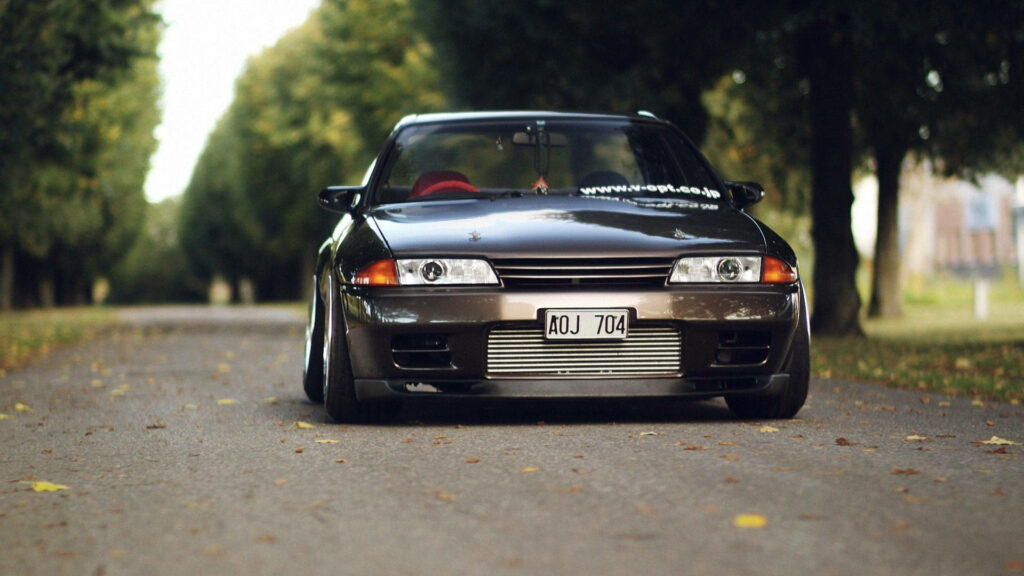 4k Dream Machine: A Stunning Front View of JDM Nissan Skyline Model with Eye-Catching Background Wallpaper