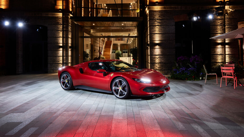 Luxury Living: 4K Exotic Car Embracing opulent living against a striking mansion backdrop Wallpaper