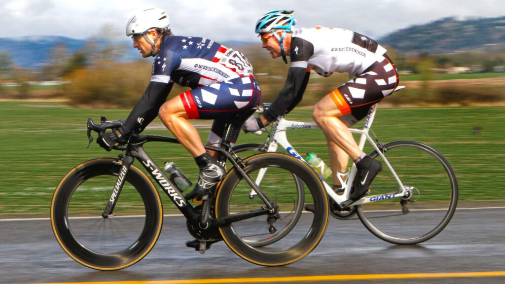 Dynamic 4K Cyclists Racing Wallpaper - Speed & Competition Scene