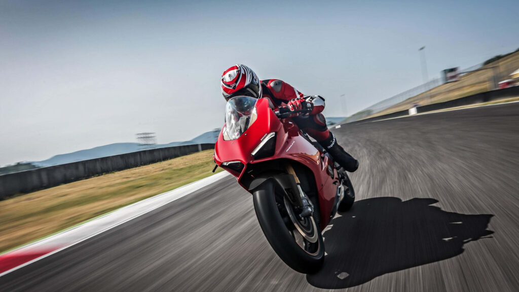 4K Wallpaper: Thrilling Red Motorcycle Racing on Track Background