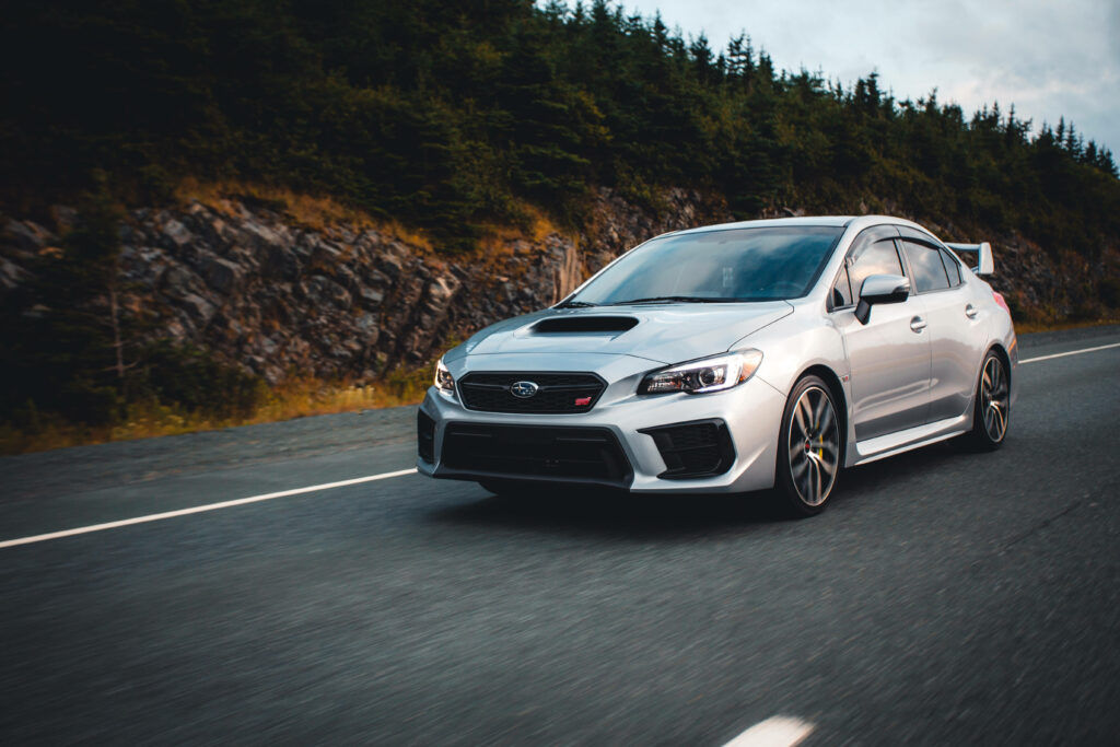 Vibrant 4K Wallpaper: Sleek Silver Subaru WRX STI in Scenic Landscape