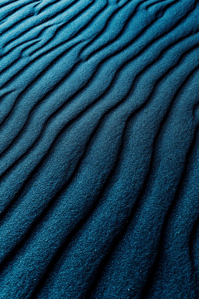 4K rippled sand dunes wallpaper in deep teal with diagonal textures for serene minimalist design