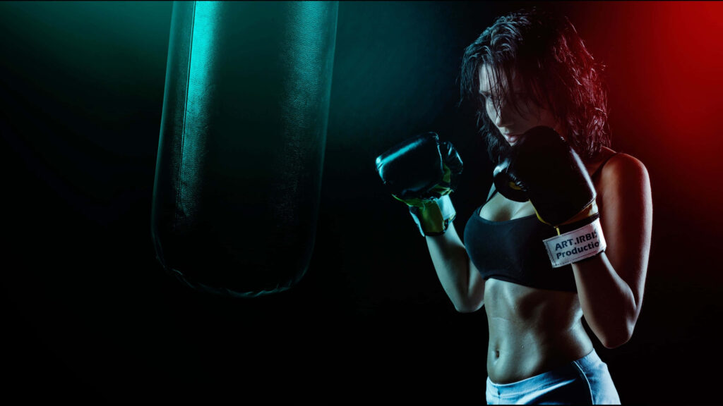 4K Wallpaper: Confident Woman in Boxing Gear in Gym Setting